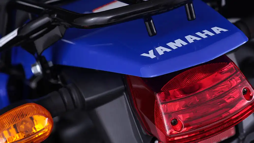 Motocicleta Yamaha XTZ125 de color negro en un paisaje montañoso, lista para conquistar caminos difíciles y desafiantes.